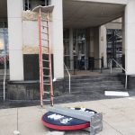 
              Pieces of the Cleveland Guardians team store sign lie on the ground in Cleveland, Friday, Nov. 19, 2021. The sign was being installed and fell off the building.  (AP Photo/Ken Blaze)
            