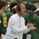 
              Baylor head coach Dave Aranda calls to his players in the second half of an NCAA college football game against Texas Tech, Saturday, Nov. 27, 2021, in Waco, Texas. (AP Photo/Jerry Larson)
            