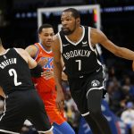 
              Brooklyn Nets forward Kevin Durant (7) drives the ball past Oklahoma City Thunder forward Darius Bazley (7) who is blocked by Nets forward Blake Griffin (2) during the first half of an NBA basketball game, Sunday, Nov. 14, 2021, in Oklahoma City. (AP Photo/Garett Fisbeck)
            