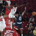 
              Houston guard Taze Moore (4) blocks a shot by Rice guard Terrance McBride (13) during the first half of an NCAA college basketball game Friday, Nov. 12, 2021, in Houston. (AP Photo/Justin Rex)
            