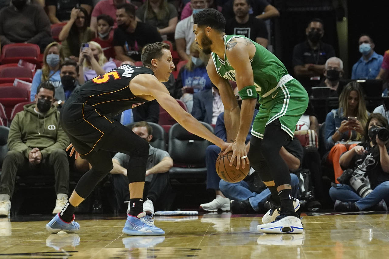 Miami Heat guard Duncan Robinson (55) defends Boston Celtics forward Jayson Tatum (0) during the fi...
