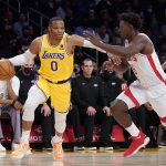 
              Los Angeles Lakers guard Russell Westbrook (0) is defended by Houston Rockets forward Jae'Sean Tate (8) during the first half of an NBA basketball game Tuesday, Nov. 2, 2021, in Los Angeles. (AP Photo/Marcio Jose Sanchez)
            
