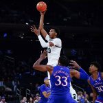 
              Michigan State's Marcus Bingham Jr. (30) shoots over Kansas' David McCormack (33) and Ochai Agbaji (30) during the first half of an NCAA basketball game Tuesday, Nov. 9, 2021, in New York. (AP Photo/Frank Franklin II)
            