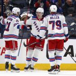 
              New York Rangers defenseman Jacob Trouba, center, celebrates his goal against the Columbus Blue Jackets with teammates forward Barclay Goodrow, left, and defenseman K'Andre Miller during the second period of an NHL hockey game in Columbus, Ohio, Saturday, Nov. 13, 2021. The Rangers won 5-3. (AP Photo/Paul Vernon)
            