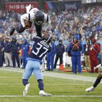 
              Houston Texans quarterback Tyrod Taylor, top, leaps over Tennessee Titans safety Amani Hooker (37) for a touchdown in the first half of an NFL football game Sunday, Nov. 21, 2021, in Nashville, Tenn. (AP Photo/Wade Payne)
            