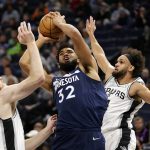 
              Minnesota Timberwolves center Karl-Anthony Towns (32) shoots between San Antonio Spurs center Jakob Poeltl (25) and guard Derrick White (4) in the first half of an NBA basketball game, Thursday, Nov. 18, 2021, in Minneapolis. (AP Photo/Andy Clayton-King)
            