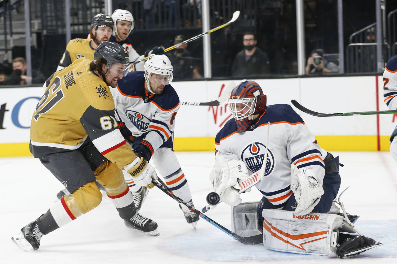Vegas Golden Knights right wing Mark Stone (61) attempts to get a rebound shot past Edmonton Oilers...