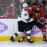 
              San Jose Sharks defenseman Mario Ferraro, left, and Chicago Blackhawks left wing Mike Hardman battle for the puck during the first period of an NHL hockey game in Chicago, Sunday, Nov. 28, 2021. (AP Photo/Nam Y. Huh)
            