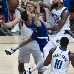 
              Dallas Mavericks center Willie Cauley-Stein (33) blocks a shot by Los Angeles Clippers guard Amir Coffey (7) during the second half of an NBA basketball game Tuesday, Nov. 23, 2021, in Los Angeles. (AP Photo/John McCoy)
            