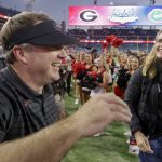 
              Georgia Bulldogs head coach Kirby Smart with his wife, Mary Beth, after the annual NCCA Georgia vs Florida game at TIAA Bank Field in Jacksonville, Fla. Georgia won 34-7.  (Bob Andres/Atlanta Journal-Constitution via AP)
            