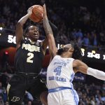 
              Purdue's Eric Hunter Jr. (2) shoots over North Carolina's R.J. Davis (4) in the second half of an NCAA college basketball game, Saturday, Nov. 20, 2021, in Uncasville, Conn. (AP Photo/Jessica Hill)
            