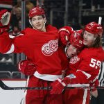 
              Detroit Red Wings left wing Lucas Raymond (23) celebrates with defenseman Moritz Seider (53) and left wing Tyler Bertuzzi (59) after scoring against the Vegas Golden Knights during the first period of an NHL hockey game Sunday, Nov. 7, 2021, in Detroit. (AP Photo/Duane Burleson)
            