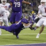 
              Washington running back Kamari Pleasant dives for a touchdown against Washington State during the first half of an NCAA college football game, Friday, Nov. 26, 2021, in Seattle. (AP Photo/Ted S. Warren)
            