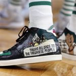 
              Boston Celtics' Enes Kanter wears a political message on his shoes during the first half of the team's NBA basketball game against the Milwaukee Bucks, Friday, Nov. 12, 2021, in Boston. (AP Photo/Michael Dwyer)
            