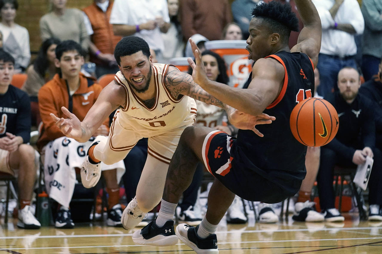 Texas forward Timmy Allen (0) is fouled by Sam Houston State guard Javion May (11) during the secon...