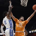 
              Tennessee's Santiago Vescovi (25) shoots as North Carolina's Caleb Love (2) defends, in the first half of an NCAA college basketball game, Sunday, Nov. 21, 2021, in Uncasville, Conn. (AP Photo/Jessica Hill)
            
