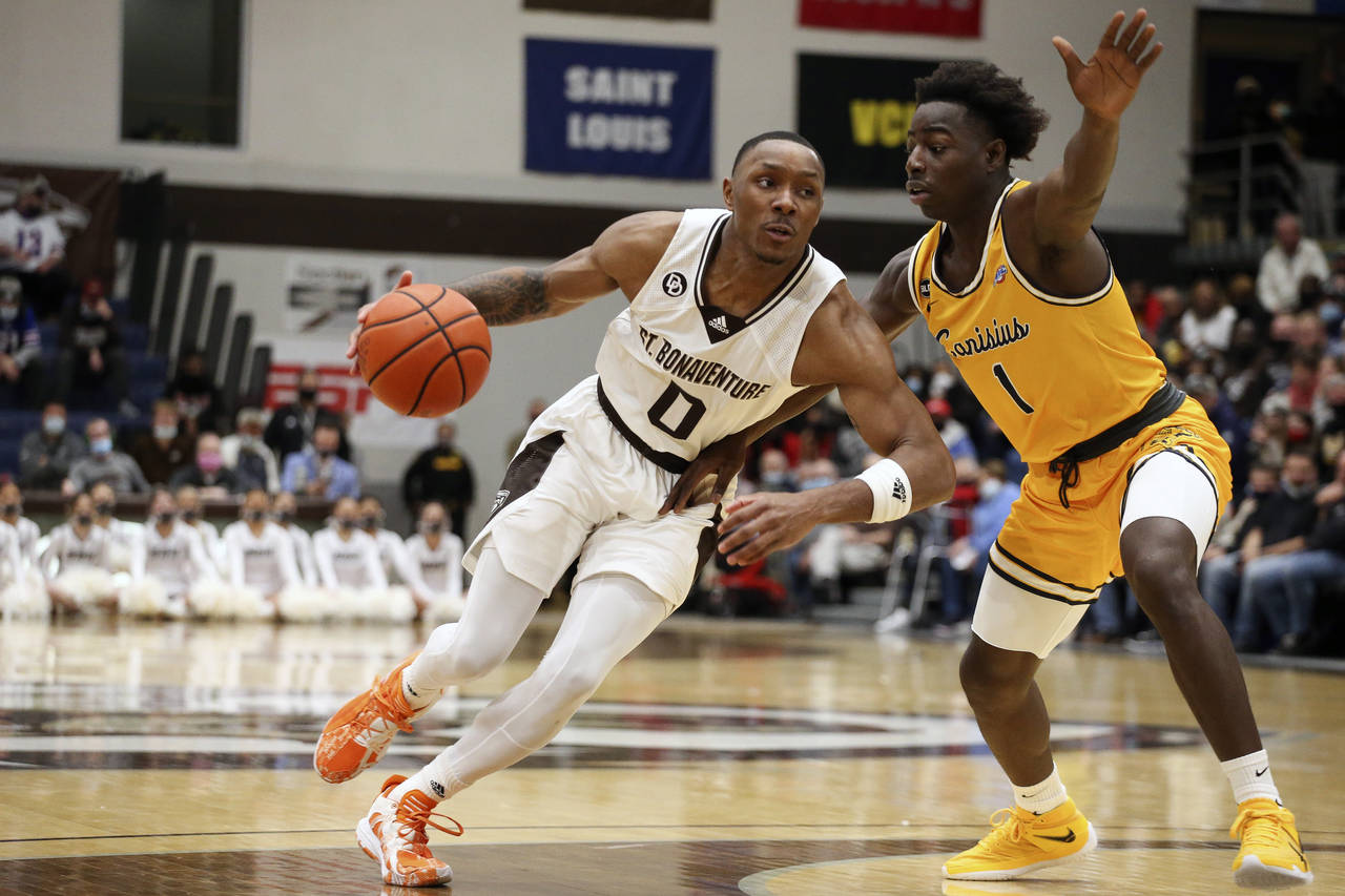 St. Bonaventure guard Kyle Lofton (0) drives to the hoop while defended by Canisius guard Ahamadou ...