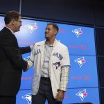 
              Ross Atkins, executive vice president of baseball operations and general manager of the Toronto Blue Jays, left, shakes hands with pitcher José Berríos during a press conference announcing his seven-year extension with the team at Rogers Centre in Toronto, Thursday, Nov. 18, 2021. (Tijana Martin/The Canadian Press via AP)
            