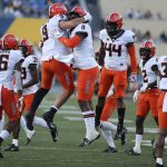 
              Oklahoma State wide receiver Matt Polk (9) linebackers Lamont Bishop (11) and Kamryn Farrar (44) celebrate after a sack against West Virginia during the second half of an NCAA college football game in Morgantown, W.Va., Saturday, Nov. 6, 2021. (AP Photo/Kathleen Batten)
            