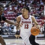 
              Alabama guard Jahvon Quinerly (13) works the ball around Oakland guard Osei Price (13) during the first half of an NCAA college basketball game, Friday, Nov. 19, 2021, in Tuscaloosa, Ala. (AP Photo/Vasha Hunt)
            