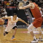 
              FILE - Japan's Yuki Togashi, left, competes against China's Zhang Zenlin during their FIBA Basketball World Cup 2023 Asian Qualifiers Group B match, Saturday, Nov. 27, 2021, in Sendai, northeastern Japan.  The East Asia Super League is set to launch next October featuring some of the region’s biggest domestic clubs. It’s banking on Asia’s home-grown talent to grow from an invitational event to the world’s third-biggest basketball league. One is the so-called Golden Boy of the Philippines. Another is the first 100 million-yen-a-season basketball player in Japan Togashi.(AP Photo/Eugene Hoshiko, File)
            