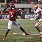 
              Louisville quarterback Malik Cunningham attempts a pass while under pressure from Clemson defensive end Xavier Thomas (3) during the second half of an NCAA college football game in Louisville, Ky., Saturday, Nov. 6, 2021. Clemson won 30-24. (AP Photo/Timothy D. Easley)
            