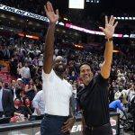 
              Former Miami Heat player Dwyane Wade, left and Miami Heat head coach Erik Spoelstra, right, wave after an NBA basketball game against the Washington Wizards, Thursday, Nov. 18, 2021, in Miami. The Heat won 112-97. (AP Photo/Lynne Sladky)
            