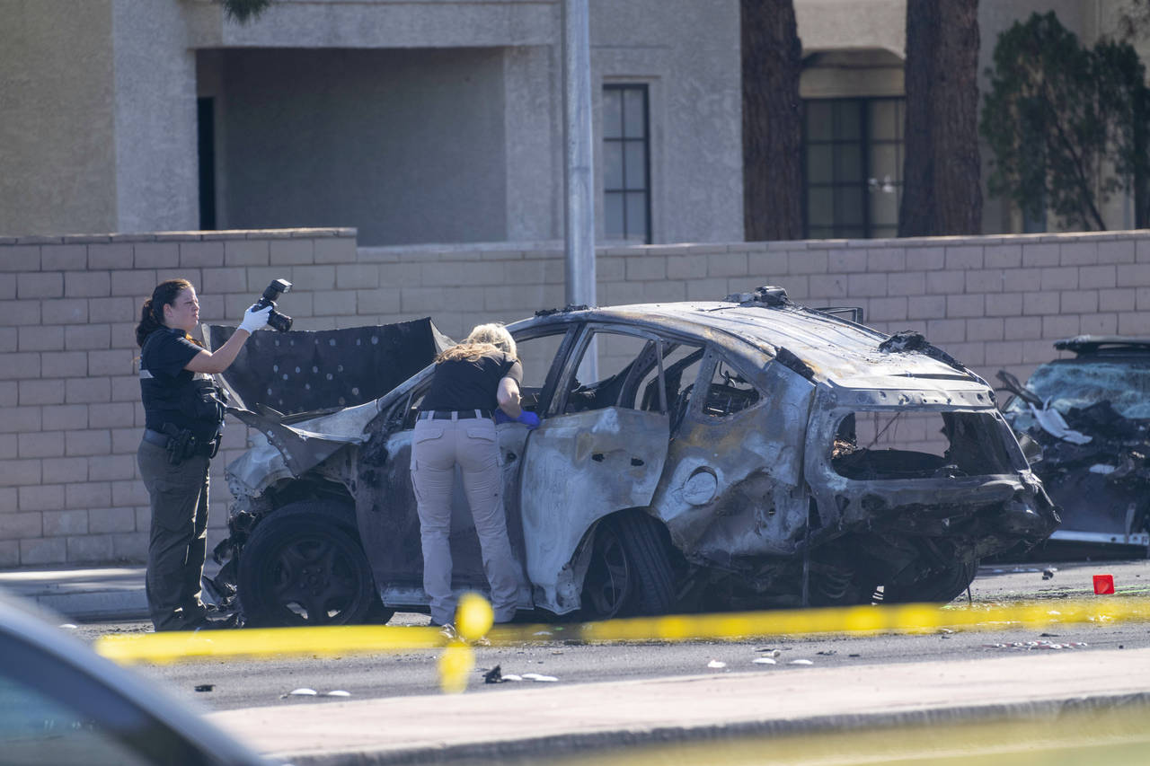 Las Vegas Metro Police investigators work at the scene of a fatal crash Tuesday, Nov. 2, 2021, in L...