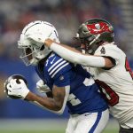 
              Indianapolis Colts' Isaiah Rodgers (34) makes an interception against Tampa Bay Buccaneers' Scott Miller (10) during the first half of an NFL football game, Sunday, Nov. 28, 2021, in Indianapolis. (AP Photo/AJ Mast)
            