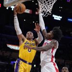 
              Los Angeles Lakers guard Russell Westbrook, left, drives to the basket as Houston Rockets guard Kevin Porter Jr. defends during the first half of an NBA basketball game Tuesday, Nov. 2, 2021, in Los Angeles. (AP Photo/Marcio Jose Sanchez)
            