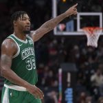 
              Boston Celtics Marcus Smart signals a play during the second half of an NBA basketball game against the Toronto Raptors Sunday, Nov. 28, 2021 in Toronto. (Chris Young/The Canadian Press via AP)
            