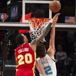 
              Atlanta Hawks John Collins (20) blocks a shot by Charlotte Hornets LaMelo Ball (2) during the first half of an NBA basketball game Saturday, Nov. 20, 2021, in Atlanta. (AP Photo/Hakim Wright Sr.)
            