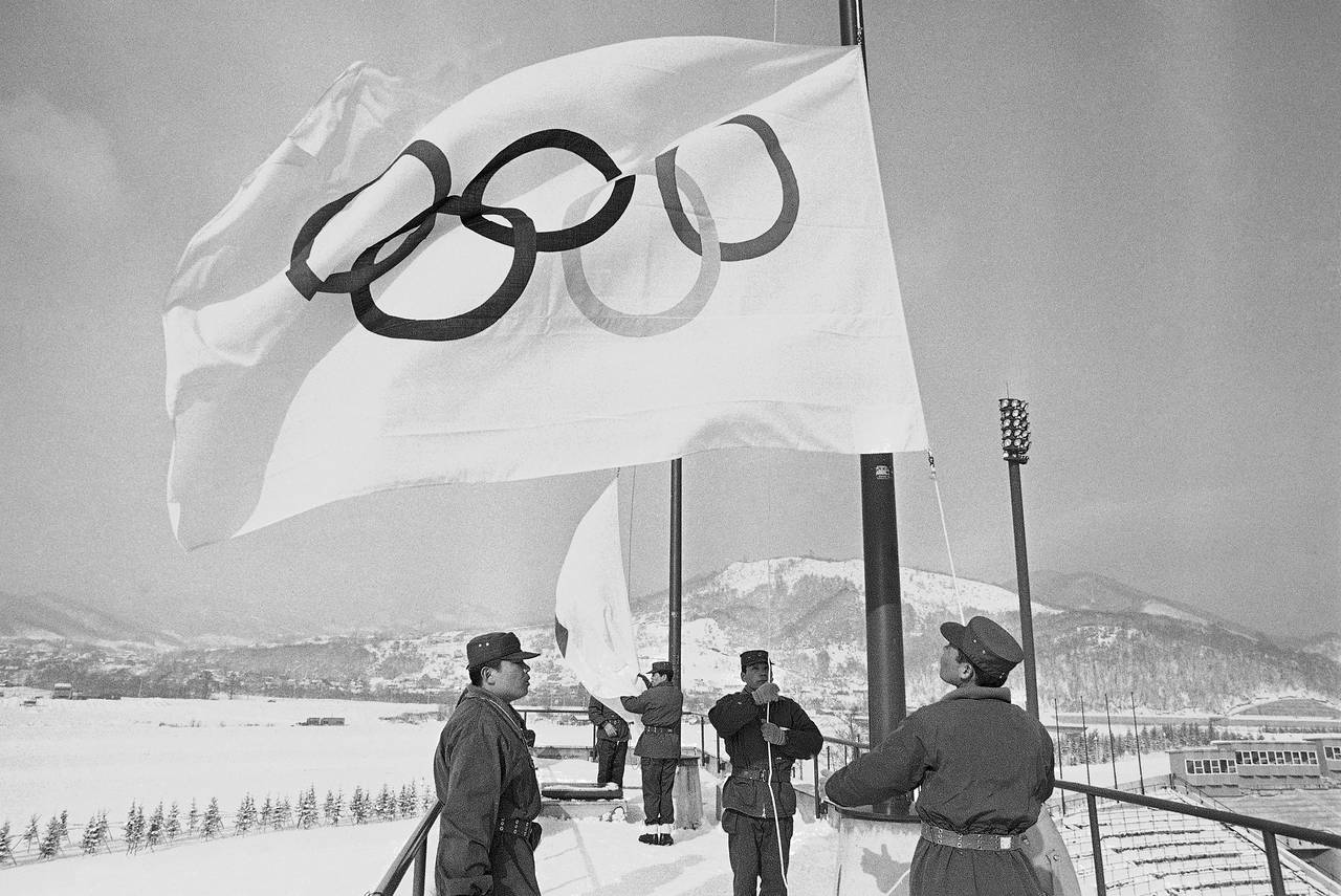 FILE - Members of Japan's self defense ground forces raise Olympic Flags on Sunday, Jan. 23, 1972, ...