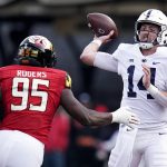 
              Penn State quarterback Sean Clifford (14) throws the ball while being hurried by Maryland defensive lineman Lawtez Rogers (95) during the first half of an NCAA college football game, Saturday, Nov. 6, 2021, in College Park, Md. (AP Photo/Julio Cortez)
            