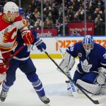 
              Toronto Maple Leafs' goaltender Jack Campbell (36) makes a save as Calgary Flames' Trevor Lewis (22) looks on during the first period of an NHL hockey game in Toronto on Friday, Nov. 12, 2021. (Frank Gunn/The Canadian Press via AP)
            