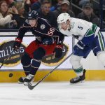 
              Columbus Blue Jackets' Eric Robinson, left, and Vancouver Canucks' Tucker Poolmann chase a loose puck during the second period of an NHL hockey game Friday, Nov. 26, 2021, in Columbus, Ohio. (AP Photo/Jay LaPrete)
            