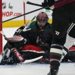 
              Arizona Coyotes goalie Scott Wedgewood (31) covers up the puck while making a save against the Dallas Stars during the second period of an NHL hockey game Saturday, Nov. 27, 2021, in Glendale, Ariz. (AP Photo/Darryl Webb)
            