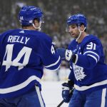
              Toronto Maple Leafs defenseman Morgan Rielly (44) celebrates his goal against the New York Rangers with teammate John Tavares (91) during second-period NHL hockey action in Toronto, Thursday, Nov. 18, 2021. (Nathan Denette/The Canadian Press via AP)
            
