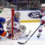 
              New York Rangers goaltender Igor Shesterkin (31) keeps his eye on the puck off a shot by New York Islanders center Casey Cizikas (53) as Rangers defensemen K'Andre Miller (79) and Nils Lundkvist (27) assist during the second period of an NHL hockey game, Wednesday, Nov. 24, 2021, in Elmont, N.Y. (AP Photo/Rich Schultz)
            