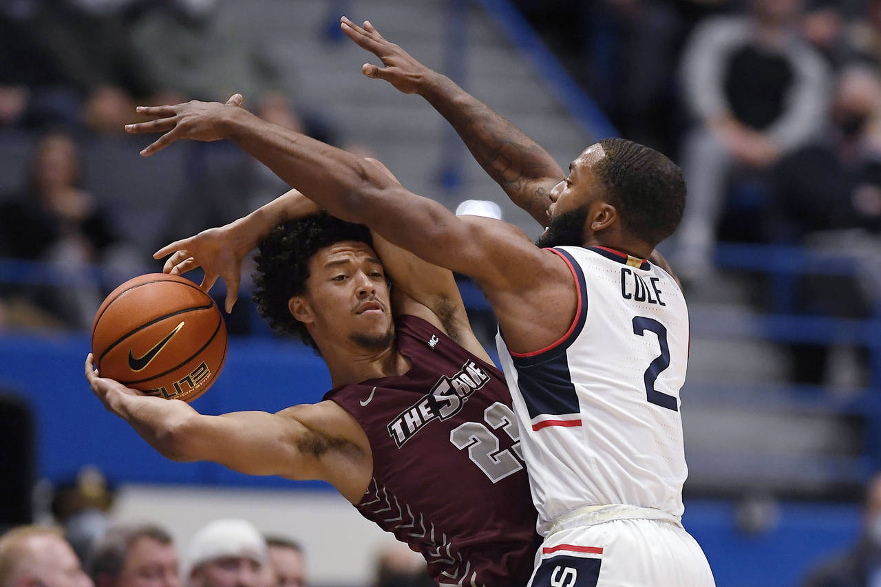 Maryland-Eastern Shore's Nathaniel Pollard Jr., left, is pressured by Connecticut's R.J. Cole in th...