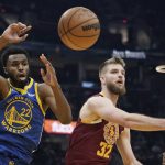 
              Cleveland Cavaliers' Dean Wade (32) and Golden State Warriors' Andrew Wiggins (22) battle for a rebound in the first half of an NBA basketball game, Thursday, Nov. 18, 2021, in Cleveland. (AP Photo/Tony Dejak)
            