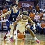 
              Texas forward Tre Mitchell, left, goes for a loose ball against California Baptist guard Taran Armstrong, left, during the first half of  an NCAA college basketball game, Wednesday, Nov. 24, 2021, in Austin, Texas. (AP Photo/Michael Thomas)
            