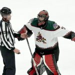 
              Arizona Coyotes goalie Scott Wedgewood confronts linesman David Brisebois (96) during the second period of an NHL hockey game Chicago Blackhawks Friday, Nov. 12, 2021, in Chicago. (AP Photo/Charles Rex Arbogast)
            