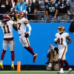 
              Washington Football Team wide receiver Terry McLaurin celebrates after scoring withwide receiver Cam Sims during the first half of an NFL football game against the Carolina Panthers Sunday, Nov. 21, 2021, in Charlotte, N.C. (AP Photo/Jacob Kupferman)
            