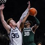 
              Michigan State forward Marcus Bingham Jr. (30) shoots over Butler forward John-Michael Mulloy (35) in the second half of an NCAA college basketball game in Indianapolis, Wednesday, Nov. 17, 2021. Michigan State defeated Butler 73-52. (AP Photo/Michael Conroy)
            