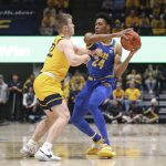 
              Pittsburgh guard William Jeffress (24) is defended by West Virginia guard Sean McNeil (22) during the first half of an NCAA college basketball game in Morgantown, W.Va., Friday, Nov. 12, 2021. (AP Photo/Kathleen Batten)
            