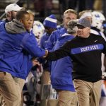 
              Kentucky head coach Mark Stoops, right, shakes hands with his staff after beating Vanderbilt in an NCAA college football game Saturday, Nov. 13, 2021, in Nashville, Tenn. (AP Photo/Mark Humphrey)
            