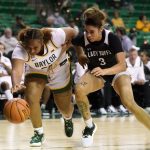 
              Baylor forward Kendra Gillispie (25) and West Texas A&M guard Haylei Janssens (3) compete for control of a loose ball in the second half of an exhibition NCAA college basketball game in Waco, Texas, Wednesday, Nov. 3, 2021. (AP Photo/Tony Gutierrez)
            