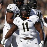
              FILE - Wake Forest defensive lineman Miles Fox (11) reacts against Army during the first half of an NCAA college football game, Oct. 23, 2021, in West Point, N.Y. Fox, a team captain for 21st-ranked Wake Forest, first played 12 games as a true freshman at Old Dominion in 2015, and then started nine of his 11 games as a sophomore and all 12 games a junior. After four games of his senior season in 2018, he decided to take advantage of a new NCAA rule that allowed him to redshirt and preserve that year of eligibility. (AP Photo/Adam Hunger)
            