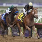 
              Victor Espinoza rides Ce Ce, right, to victory past Joel Rosario, riding Edgeway, during the Breeders' Cup Filly & Mare Sprint race at Del Mar in Del Mar, Calif., Saturday, Nov. 6, 2021. (AP Photo/Jae C. Hong)
            